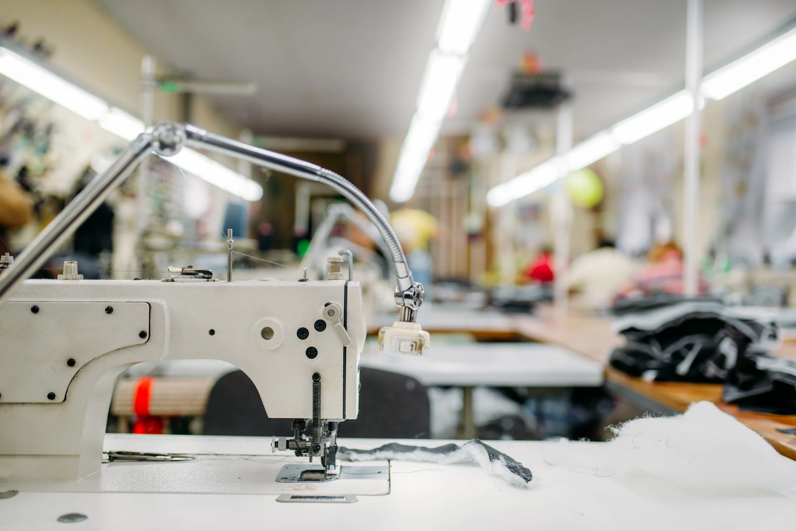 VistaCreate-181206850-stock-photo-modern-sewing-machine-closeup-dressmaker-equipment-cloth-industry-factory-production